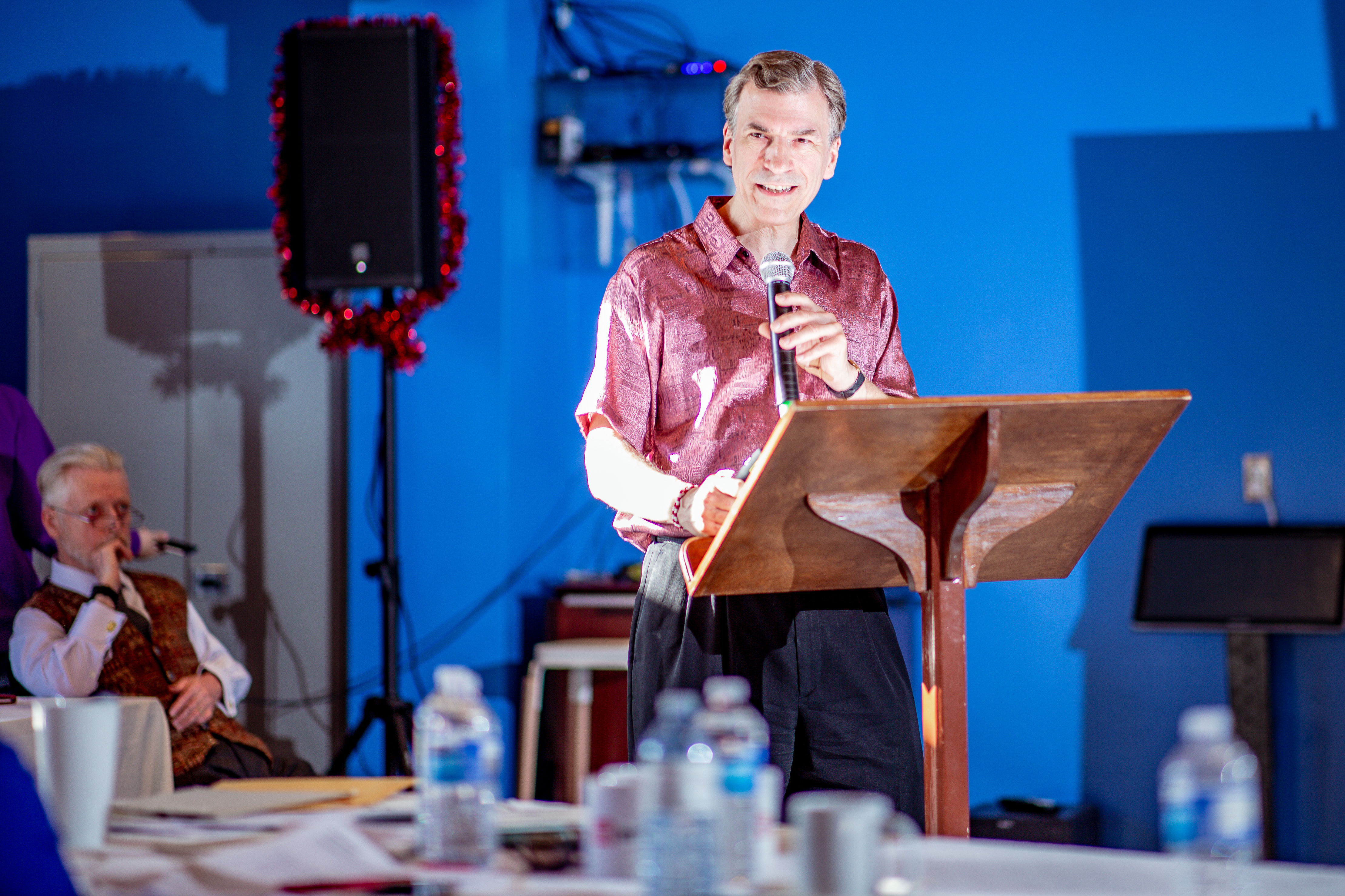 A gallery of Dr. Christopher DiCarlo at different events, promoting a previous book and playing drums with his band.